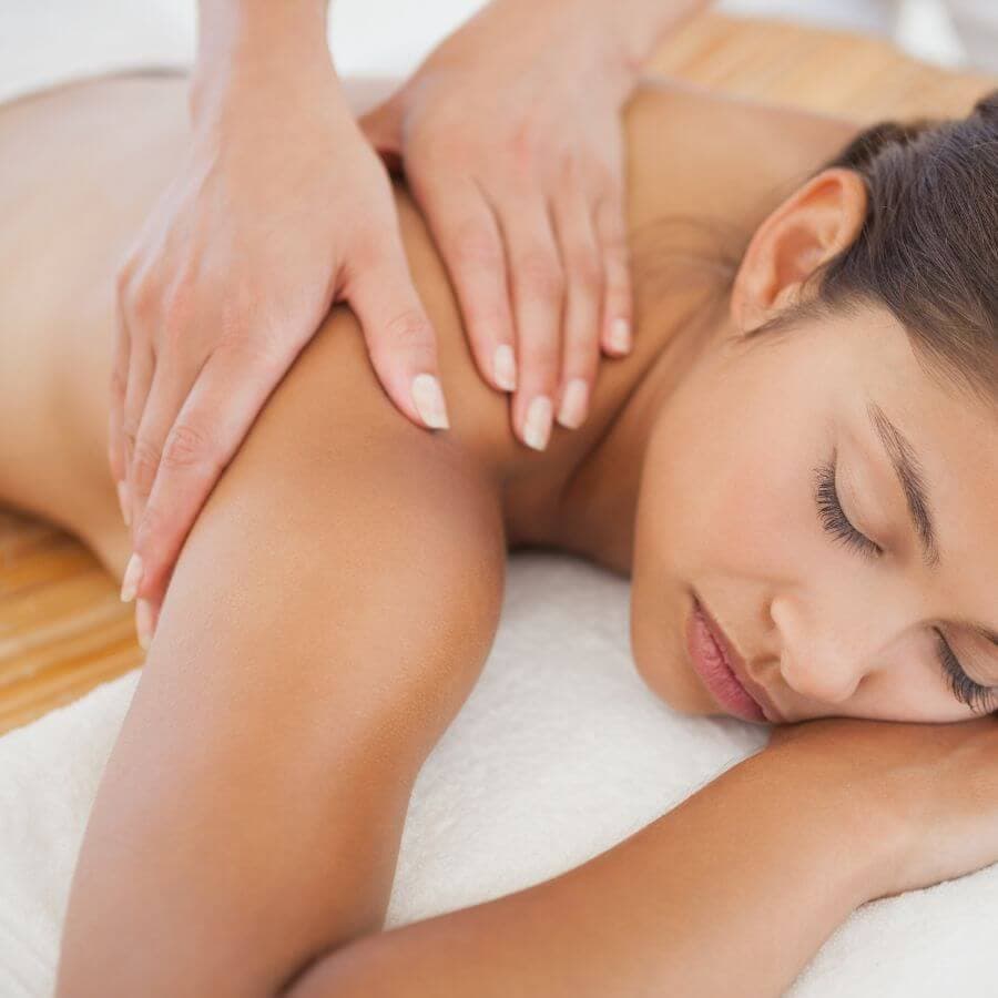 A woman relaxes during a back massage.